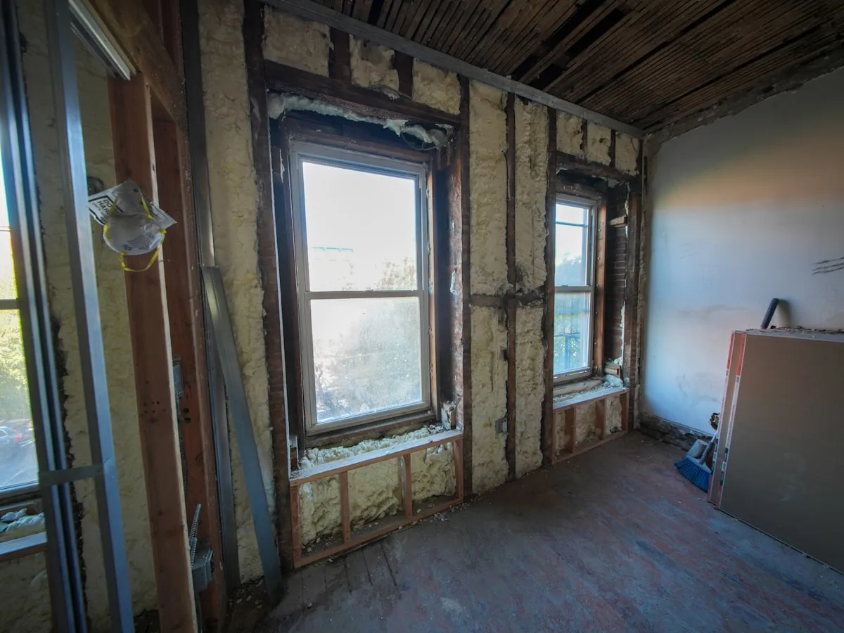 Room interior with exposed stud walls prepared for insulation