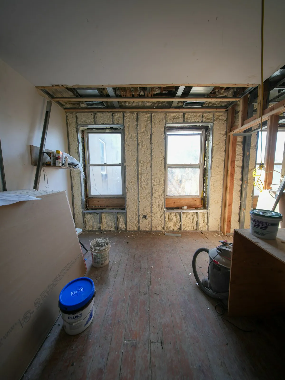 Interior of a home mid-renovation with fresh drywall and natural light